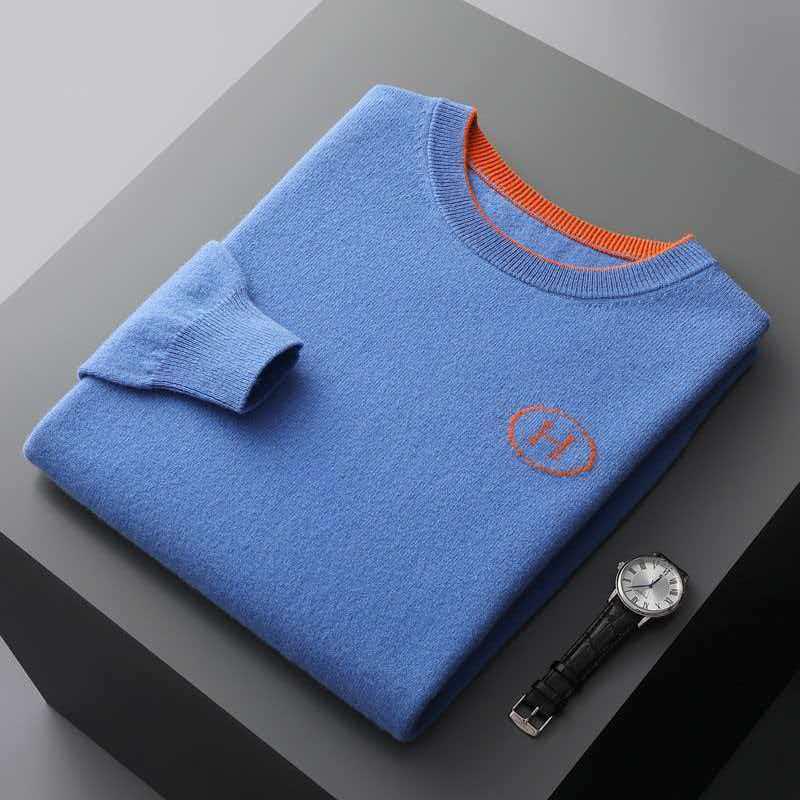 Hermes Men's Cashmere Knitwear Luxury Warm Sweater in blue with orange accents folded on a gray background with a watch.