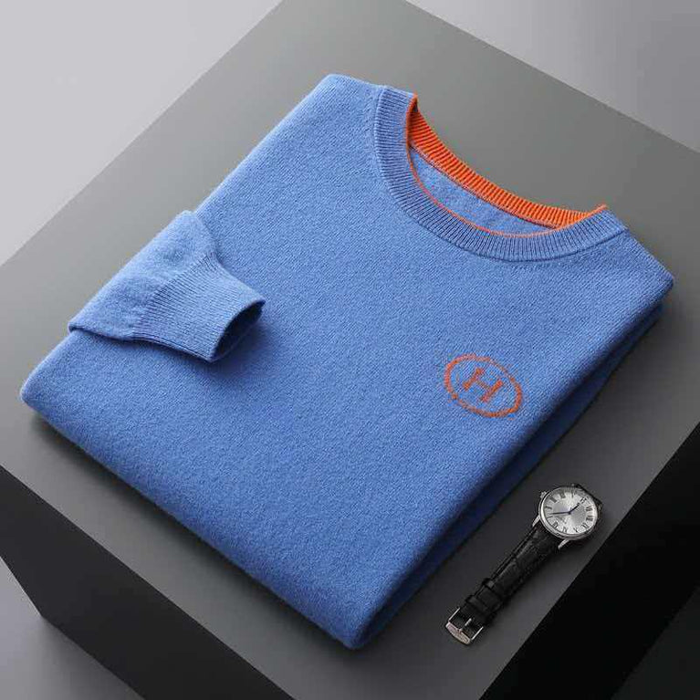 Hermes Men's Cashmere Knitwear Luxury Warm Sweater in blue with orange accents folded on a gray background with a watch.