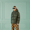 Man wearing green quilted Gucci jacket and sunglasses