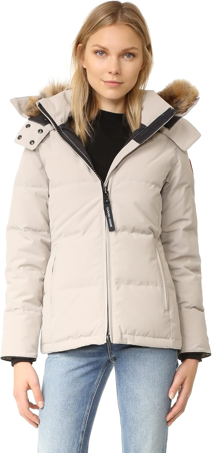 Canada Goose Chelsea Parka Women's Down Winter Jacket at Volonka store. Woman wearing a beige puffer jacket with fur-lined hood.