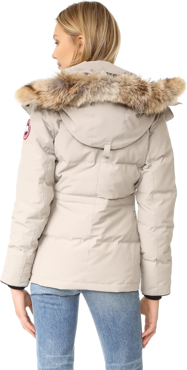 Beige parka with fur hood worn by a person. Canada Goose Chelsea Parka Women's Down Winter Jacket at Volonka store.
