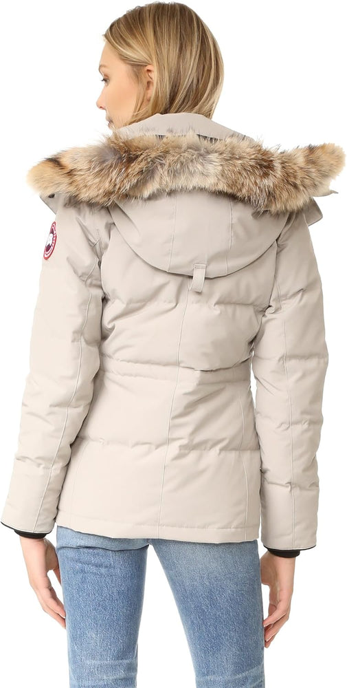 Beige parka with fur hood worn by a person. Canada Goose Chelsea Parka Women's Down Winter Jacket at Volonka store.