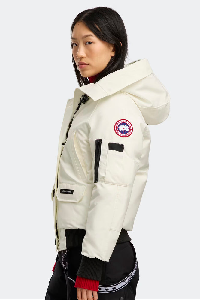 woman wearing a white Canada Goose jacket. Canada Goose Chilliwack Bomber Women's Winter Hooded Jacket