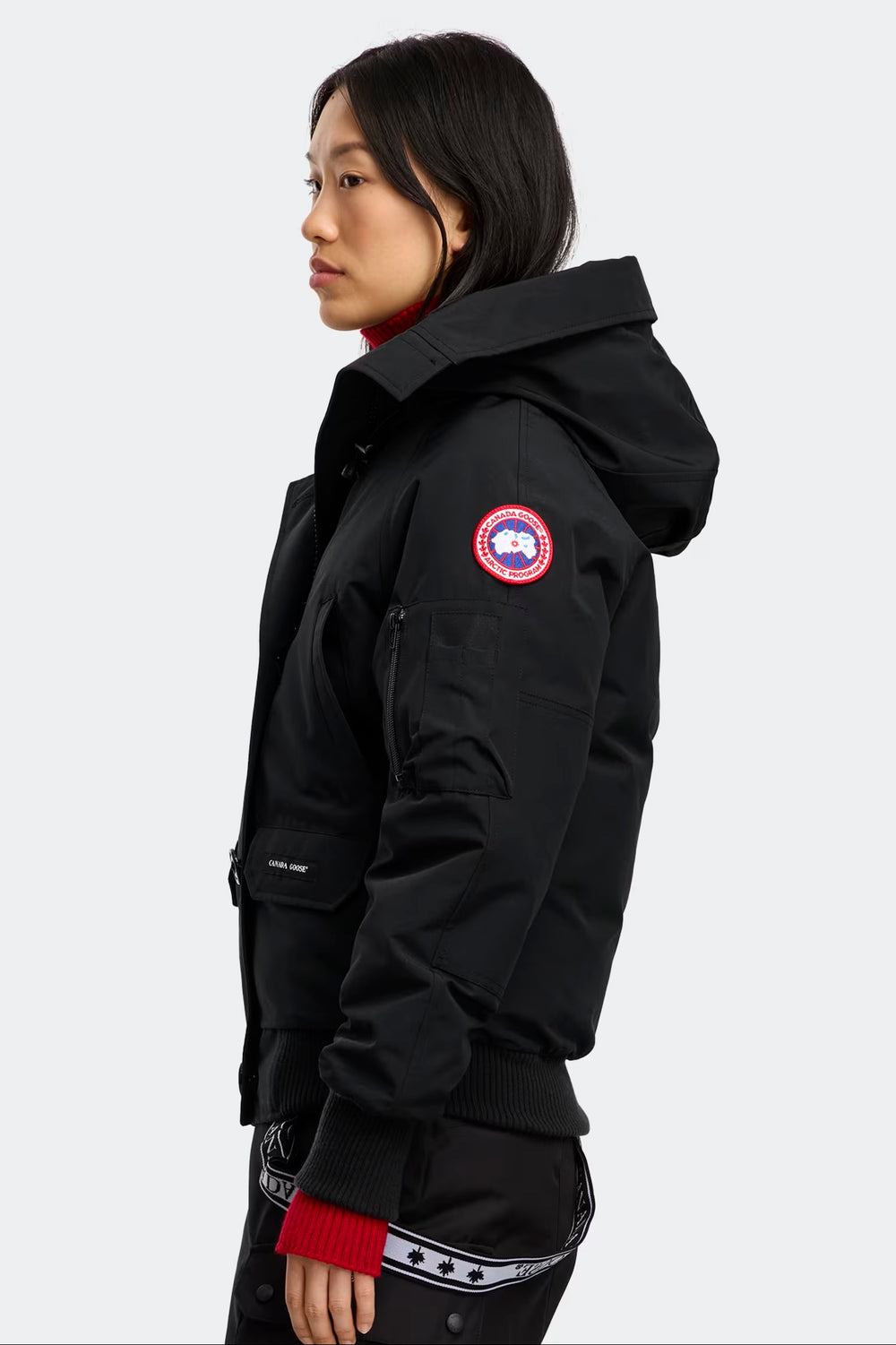 Person wearing a black parka with a visible brand logo on a white background