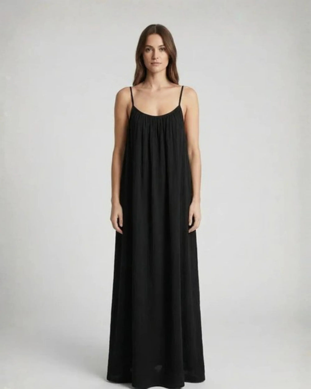 Woman wearing a Backless Loose Home Long Dress in black, showcasing a relaxed and stylish look.