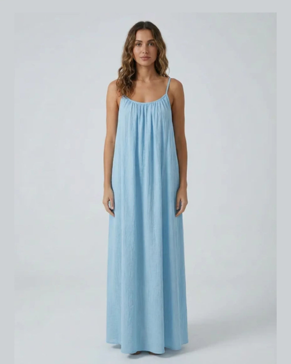 Woman wearing a Backless Loose Home Long Dress in light blue, showcasing a relaxed and stylish look.