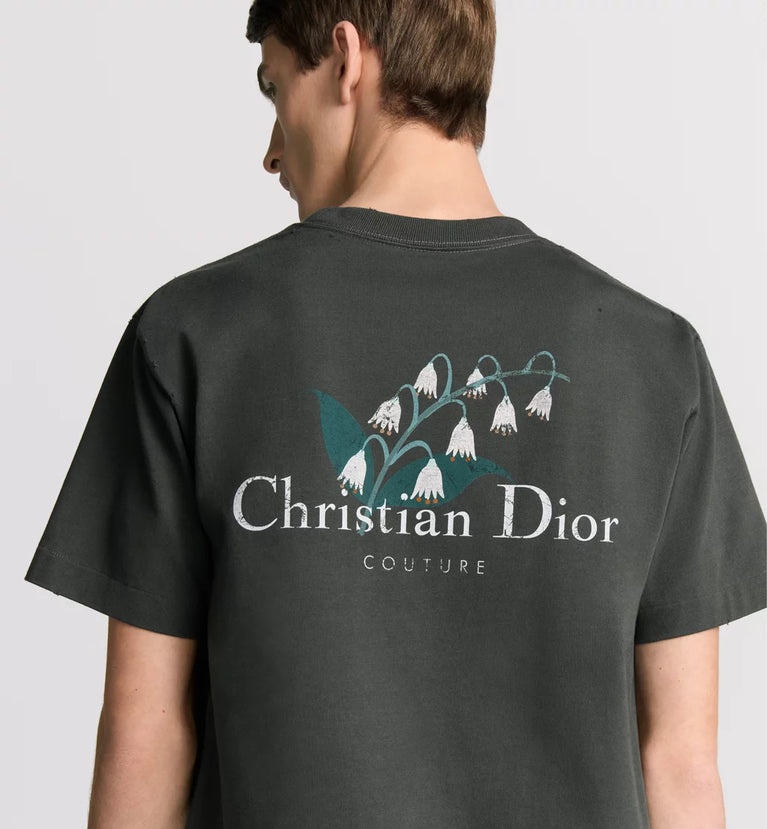 man wearing a black Christian Dior t-shirt with floral design on the back.