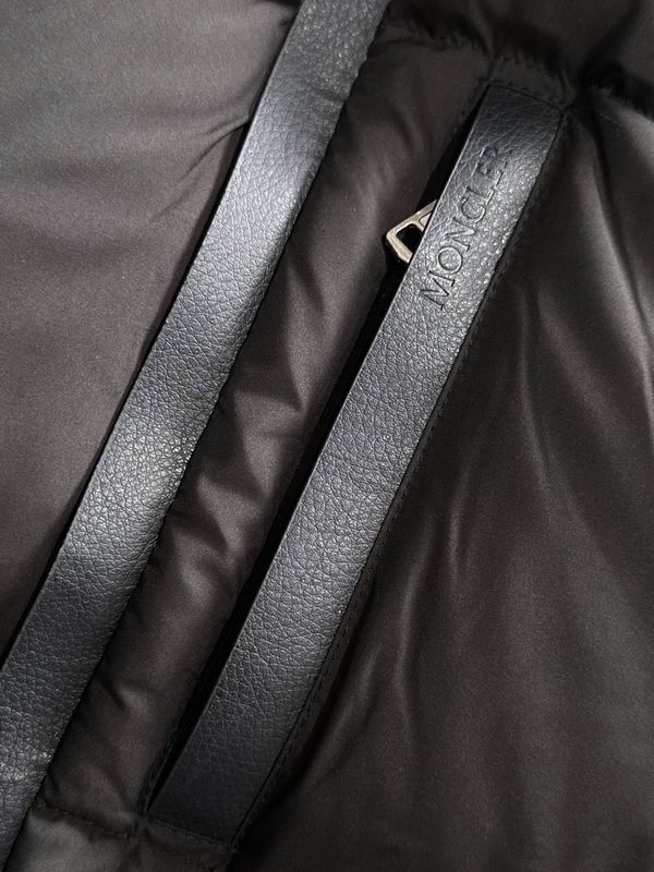 Close-up of a black jacket with a visible brand logo on a dark background