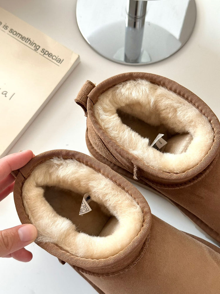 Brown slippers with fluffy interior in volonka store. UGG Classic Ultra Mini Women's Warm Wool Snow Boots