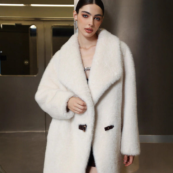 Woman wearing a white fur coat in an indoor setting