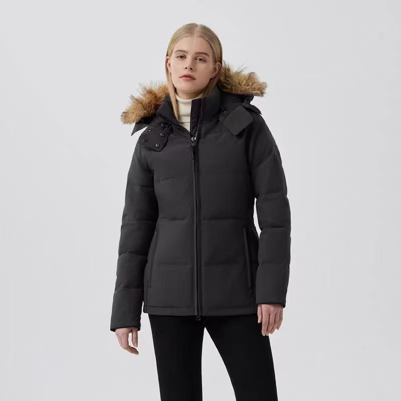 Woman wearing a black winter coat with fur-lined hood. Canada Goose Chelsea Parka Women's Down Winter Jacket at Volonka store.