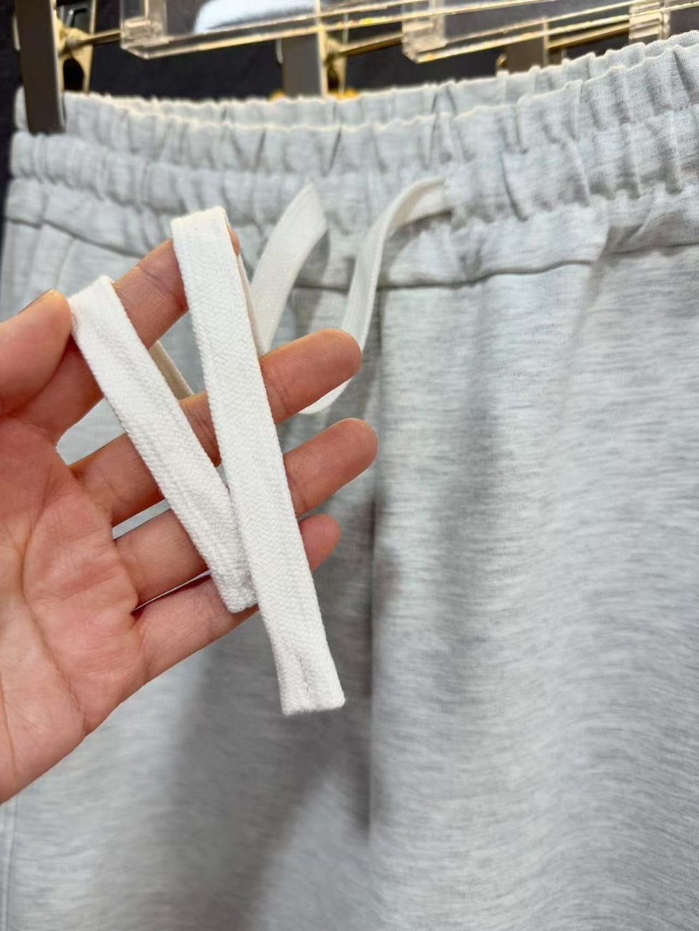 Ralph Lauren Women's Pony Straight Leg Pants. White shoelace held by a hand with gray pants in the background