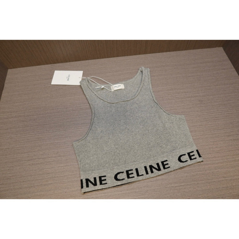Gray tank top with 'CELINE' branding on a wooden surface