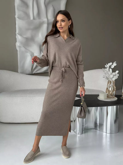 Woman in a brown outfit standing in a modern living room. Chic Elegant Soft Knit Sweater with Skirt Set at Volonka.