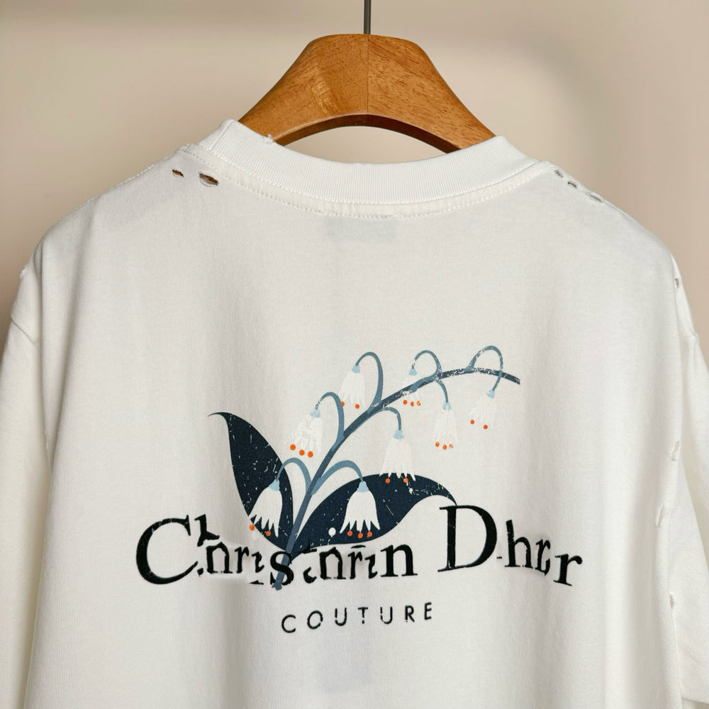 Christian Dior Couture White sweatshirt with a logo on a wooden hanger against a beige background