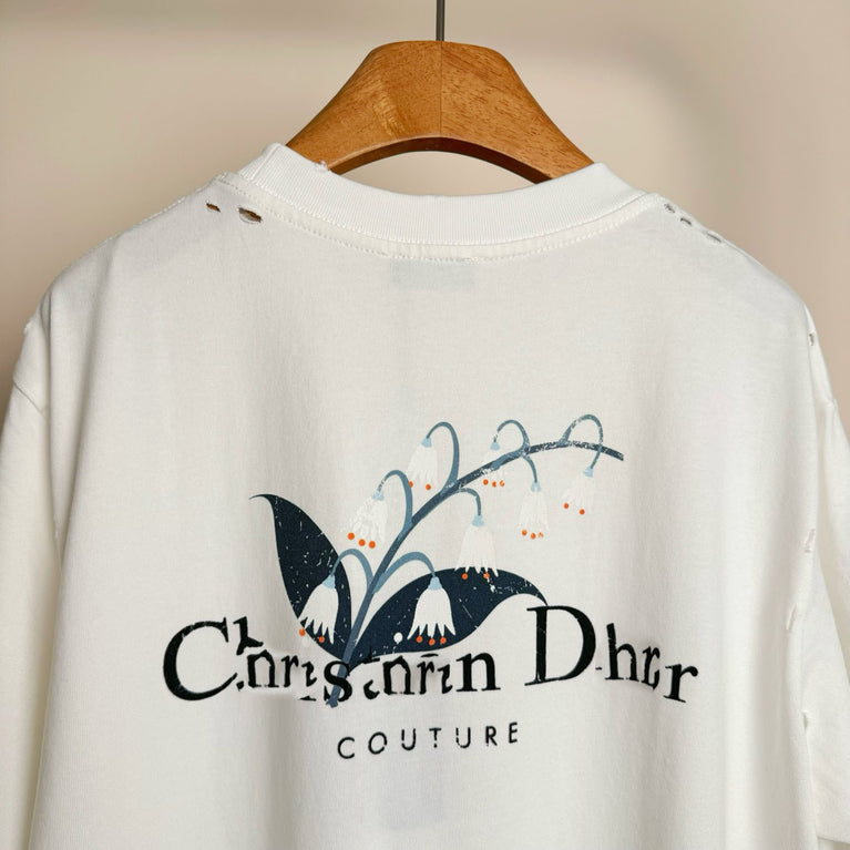 Christian Dior Couture White sweatshirt with a logo on a wooden hanger against a beige background