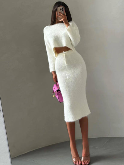 Woman wearing a white outfit with a brown belt. Luxury Fuzzy Knit Two Piece Skirt Set Chic Celebrity Style at Volonka