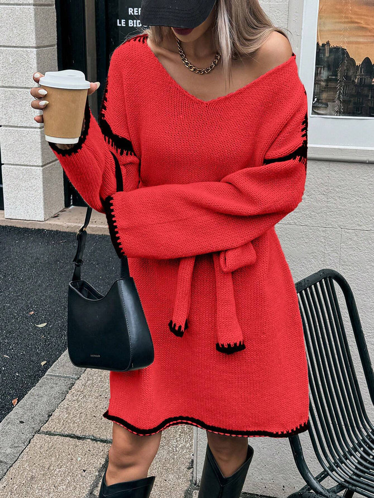 Woman wearing a red sweater dress with black trim, holding a coffee cup and a black handbag. Womens Knit V-Neck Midi Dress Tie-Waist Loose Autumn Style at Volonka.