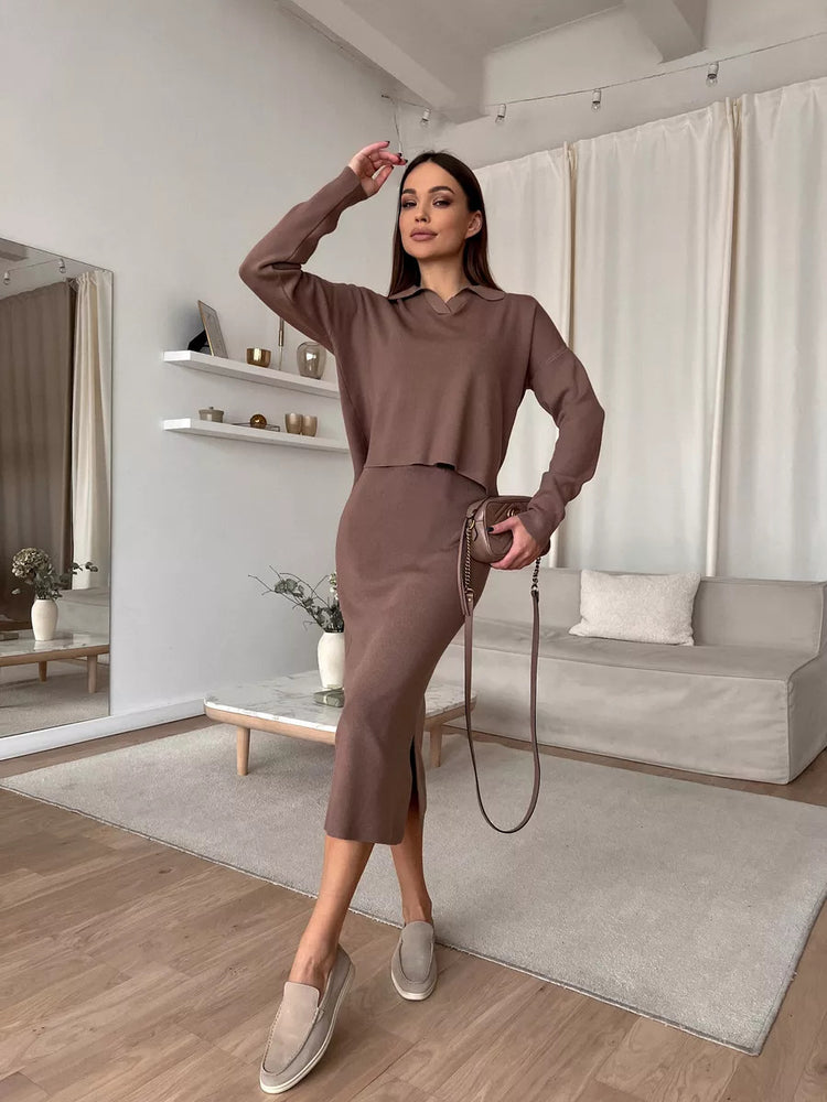 Woman in a brown outfit standing in a modern living room.