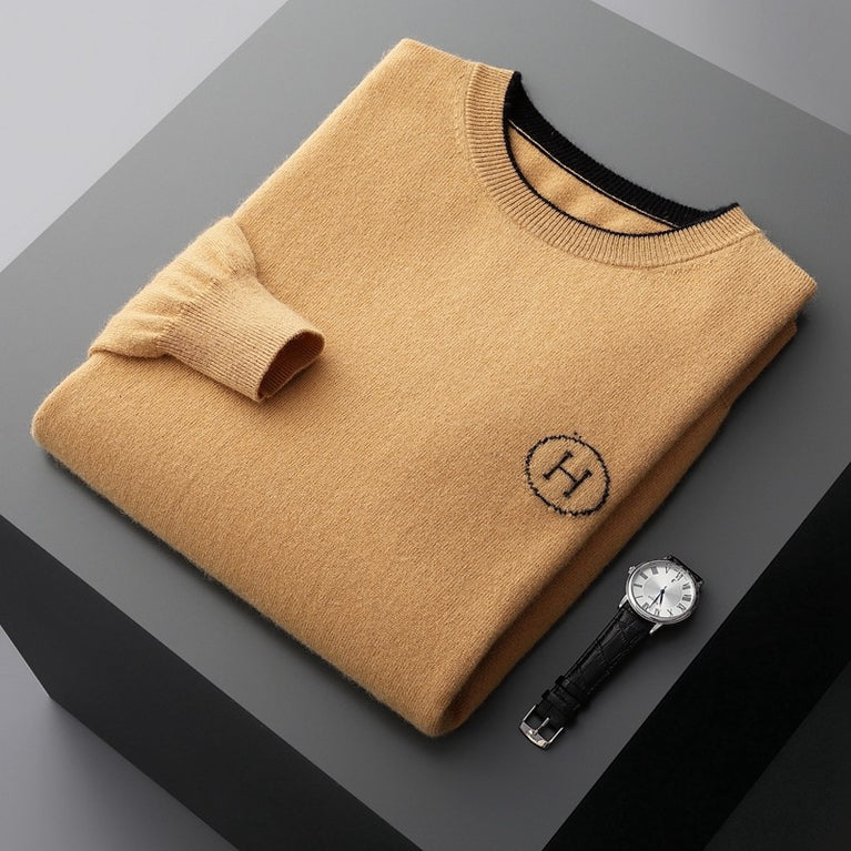 Hermes Men's Cashmere Knitwear Luxury Warm Sweater folded with a watch on a gray surface.