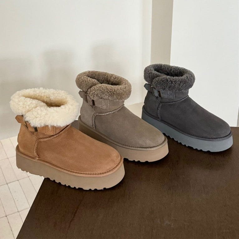 UGG Furry Belted Women's Snow Boot with Thick Platform Sole. Three pairs of winter boots with fur-lined tops on a wooden surface.