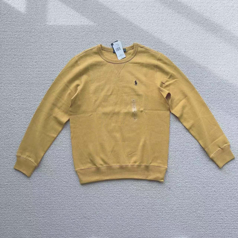 Yellow crew Polo Ralph Lauren neck sweatshirt laid flat on white background