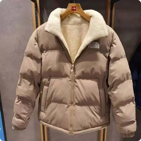 The NorthFace Two Sided Coat for Women and Men. Beige puffer jacket with white fur lining on a hanger.