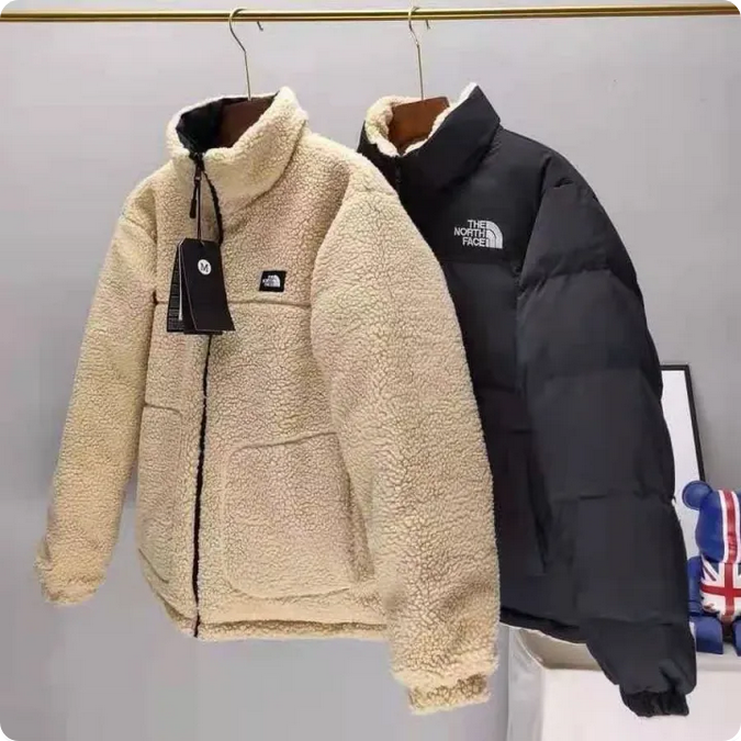 The NorthFace Two Sided Coat for Women and Men. Two jackets, one beige and one black, on hangers with 'The North Face' logo.