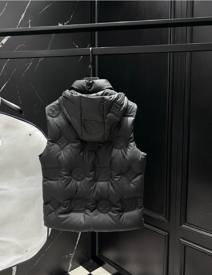 Men's Hooded Duck Down Vest Versatile Autumn Winter Jacket. Black puffer vest hanging on a rack against a black marble wall.