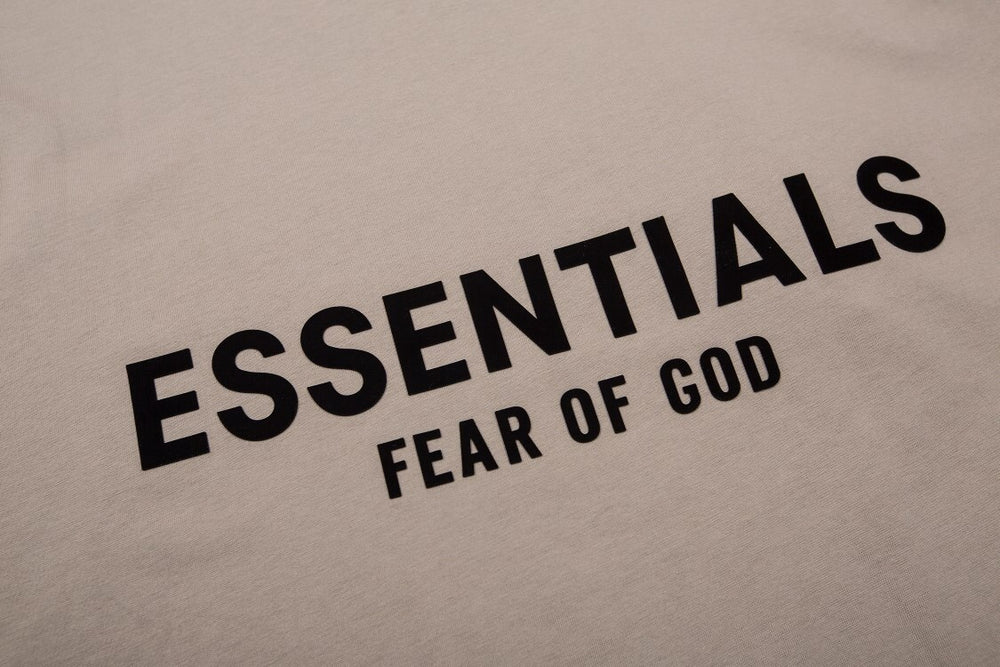 FEAR OF GOD ESSENTIALS Tshirt with Logo showcasing minimalist design and bold typography on the back.