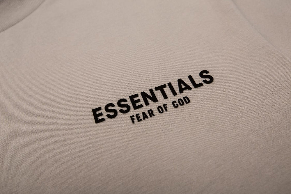 FEAR OF GOD ESSENTIALS Tshirt with Logo showcasing minimalist design and bold typography on the back.