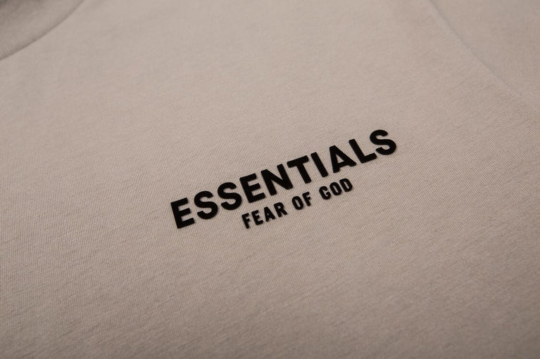 FEAR OF GOD ESSENTIALS Tshirt with Logo showcasing minimalist design and bold typography on the back.