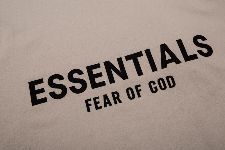FEAR OF GOD ESSENTIALS Tshirt with Logo showcasing minimalist design and bold typography on the back.