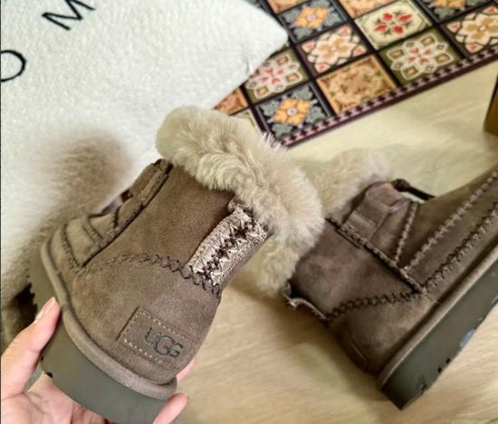 Brown UGG boots with fur lining on a patterned rug. UGG Classic Mini Alpine Women's Winter Snow Boots at volonka