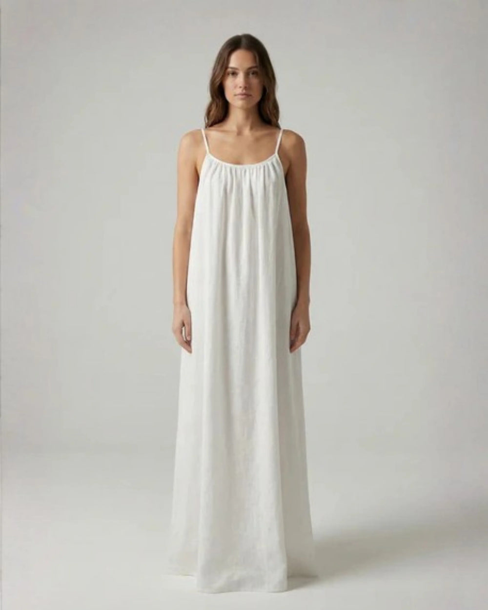 Woman wearing a Backless Loose Home Long Dress in white, showcasing a relaxed and stylish look.