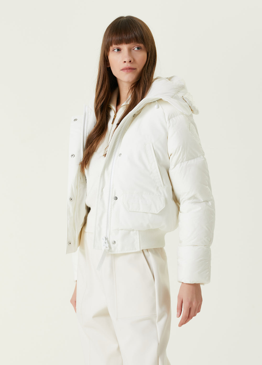 Woman wearing a white puffer jacket and pants, Canada Goose Paradigm Chilliwack Bomber Unisex Down Jacket at Volonka store.