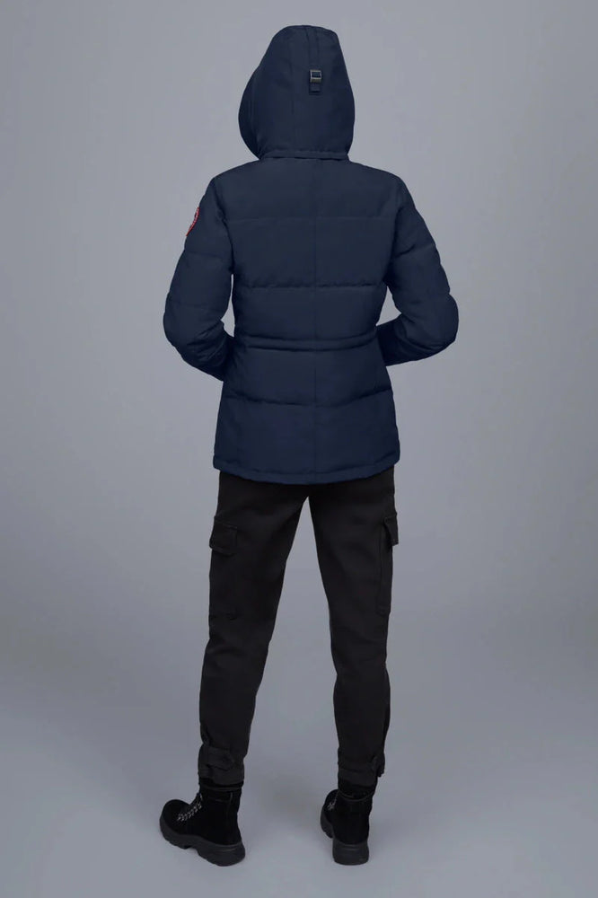 Woman wearing a navy blue puffer jacket, Canada Goose Chelsea Parka Women's Down Winter Jacket at Volonka store.