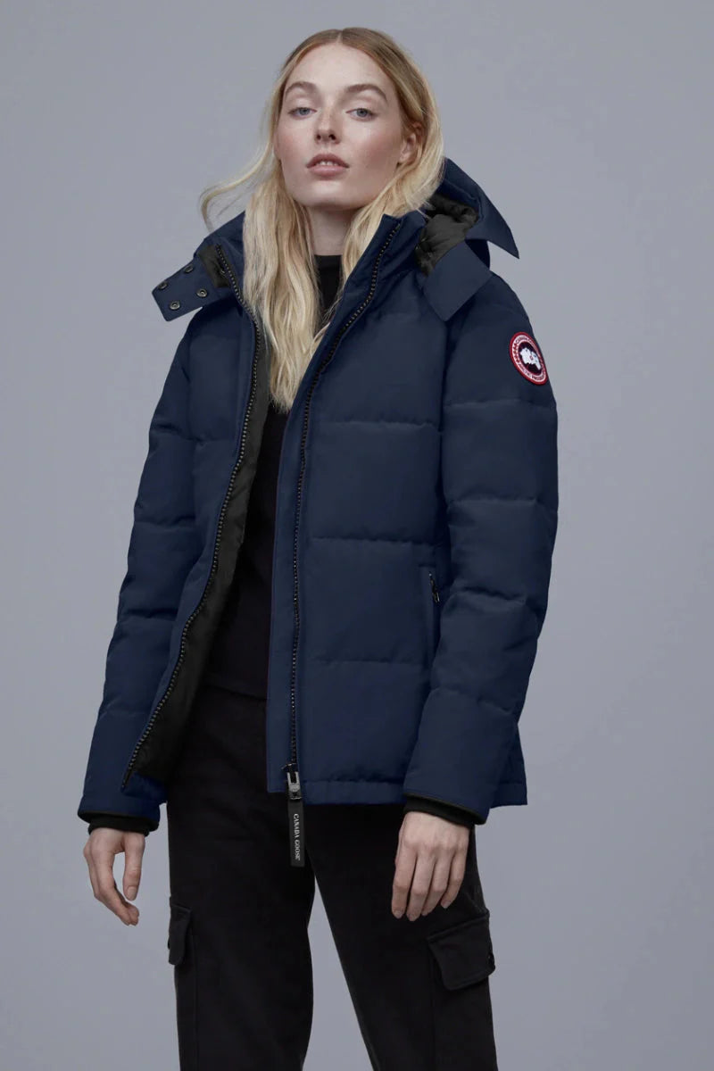 Woman wearing a navy blue puffer jacket with a brand logo, Canada Goose Chelsea Parka Women's Down Winter Jacket at Volonka store.