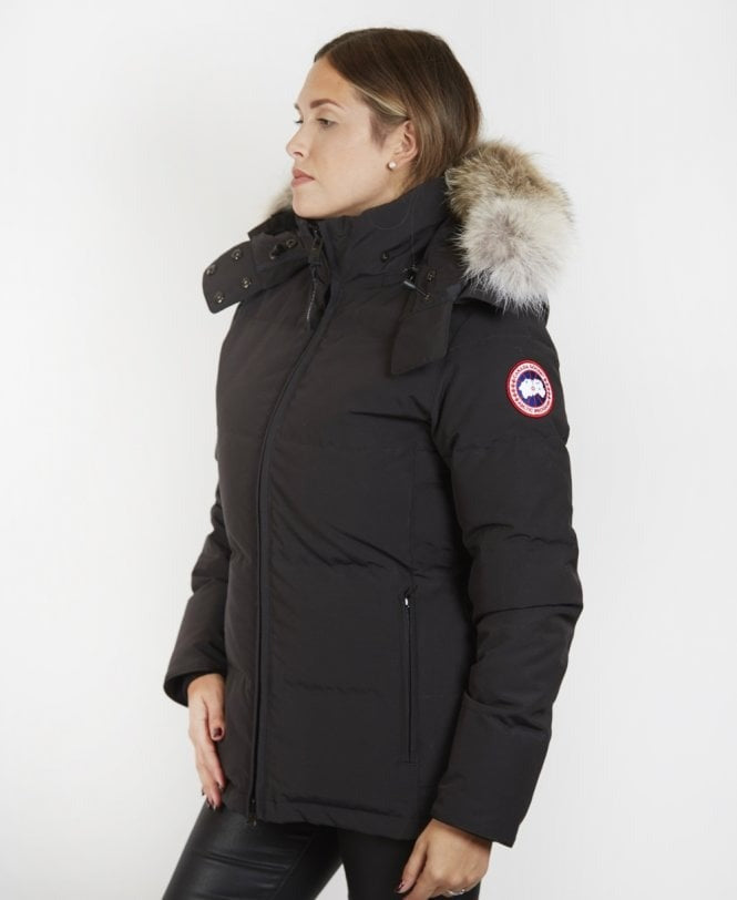Canada Goose Chelsea Parka Women's Down Winter Jacket at Volonka, Person wearing a black Canada Goose jacket with a fur-lined hood.