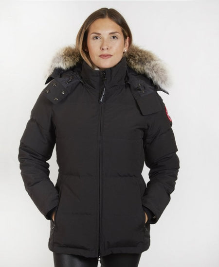 Woman wearing a black winter coat with fur-lined hood, Canada Goose Chelsea Parka Women's Down Winter Jacket