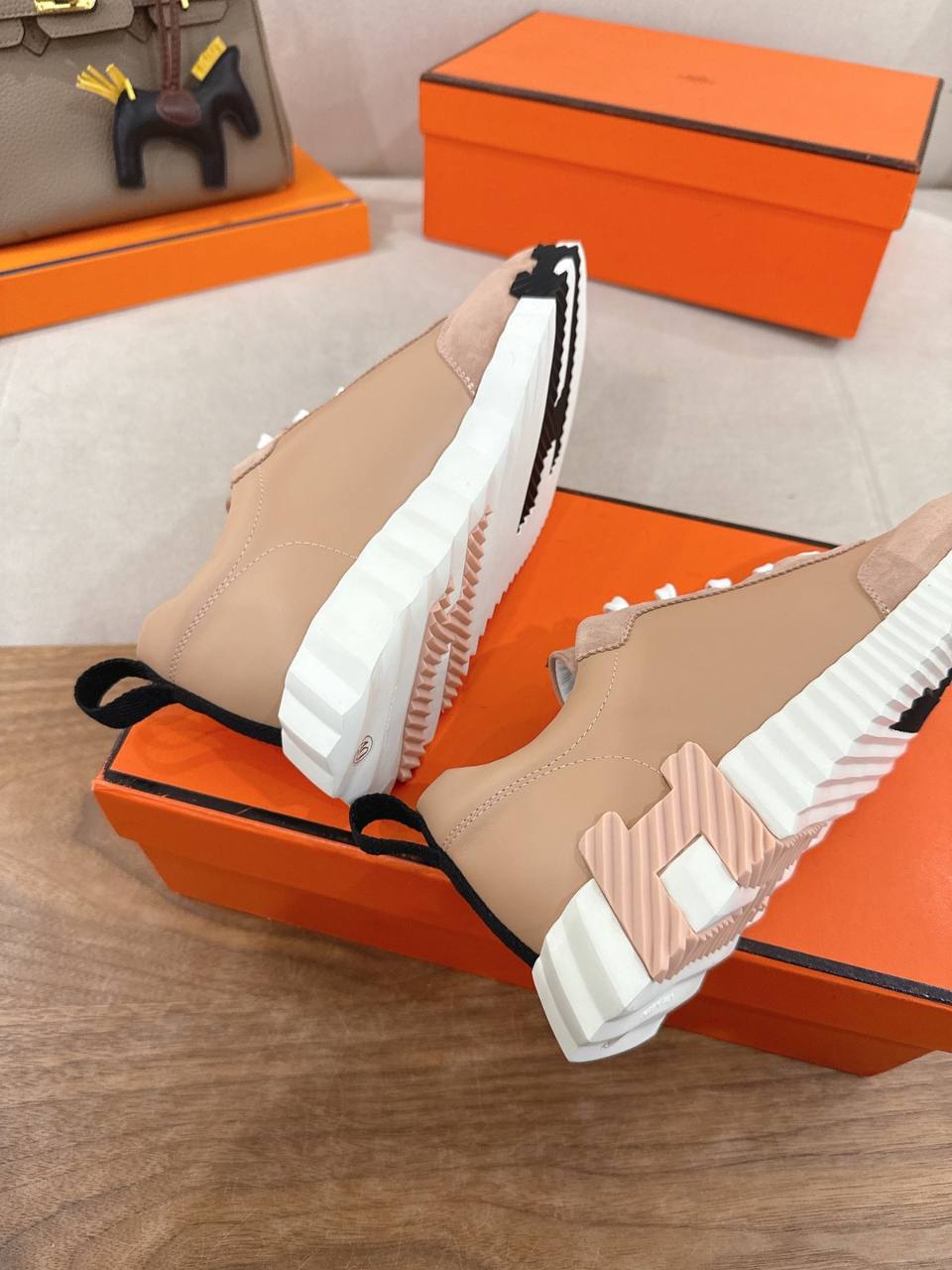 Hermes Unisex Bouncing Sneakers in pink suede with white laces and unique sole design.