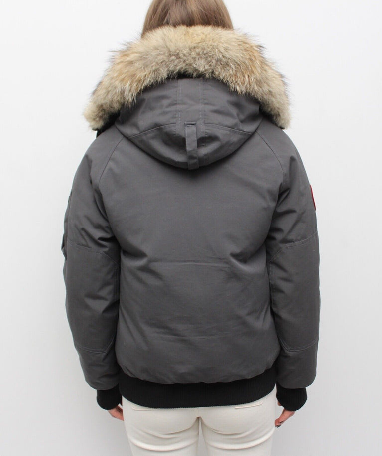 Gray winter jacket with fur hood on a white background. Canada Goose Chilliwack Bomber Women's Winter Hooded Jacket